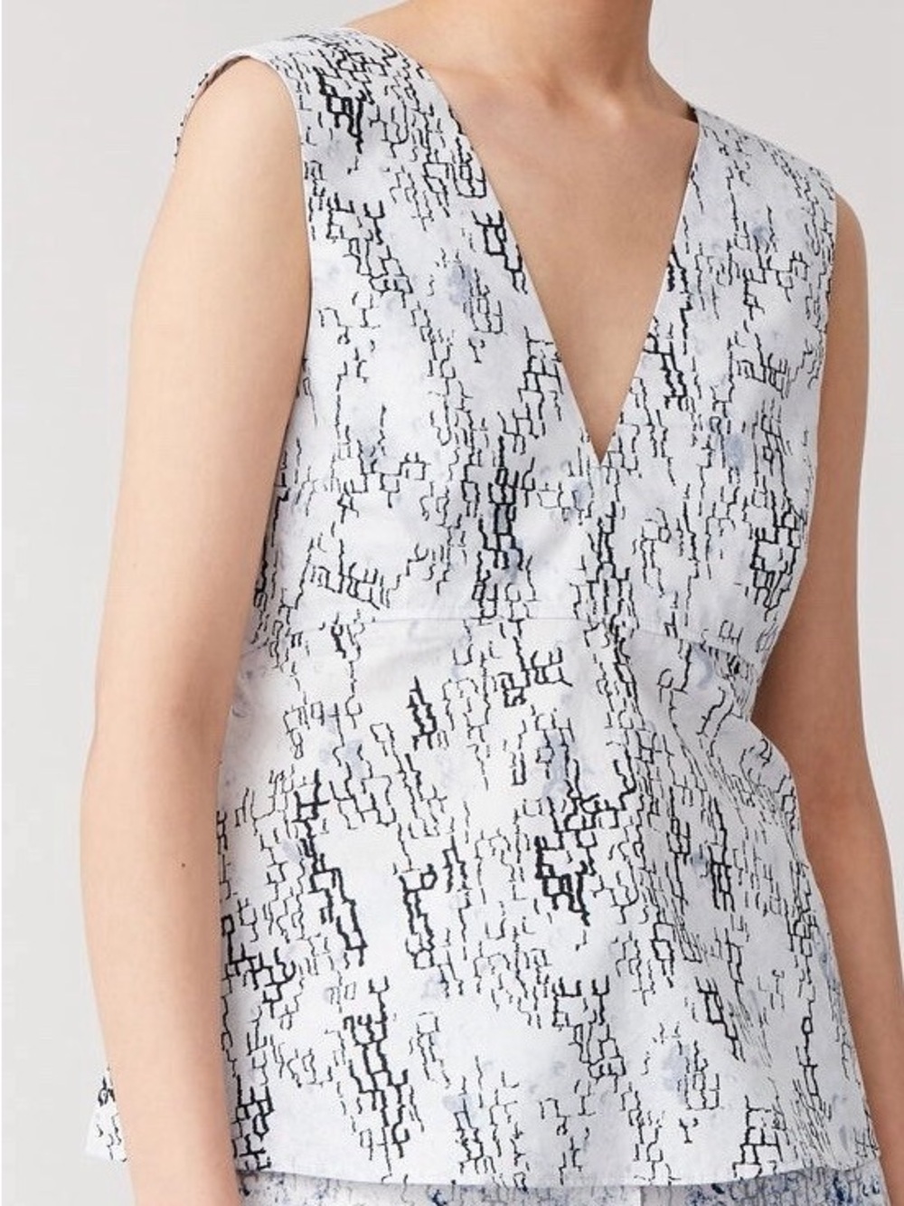 COS sleeveless top with a blue and black abstract geometric pattern